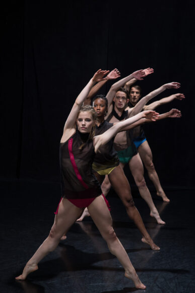 A group of dancers with their arms outstretched.
