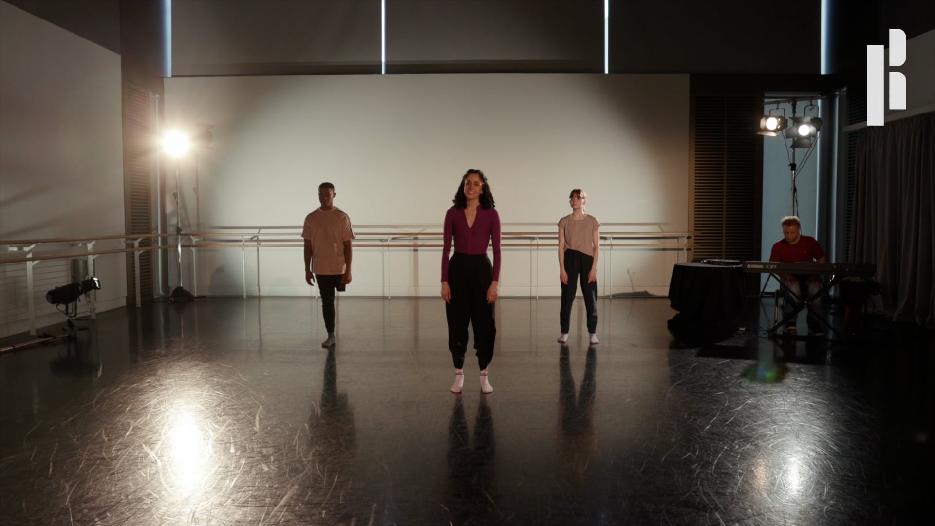 A group of dancers in an empty dance studio.