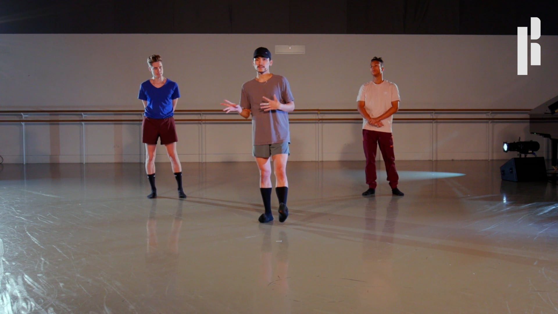 A group of people standing in a dance studio.