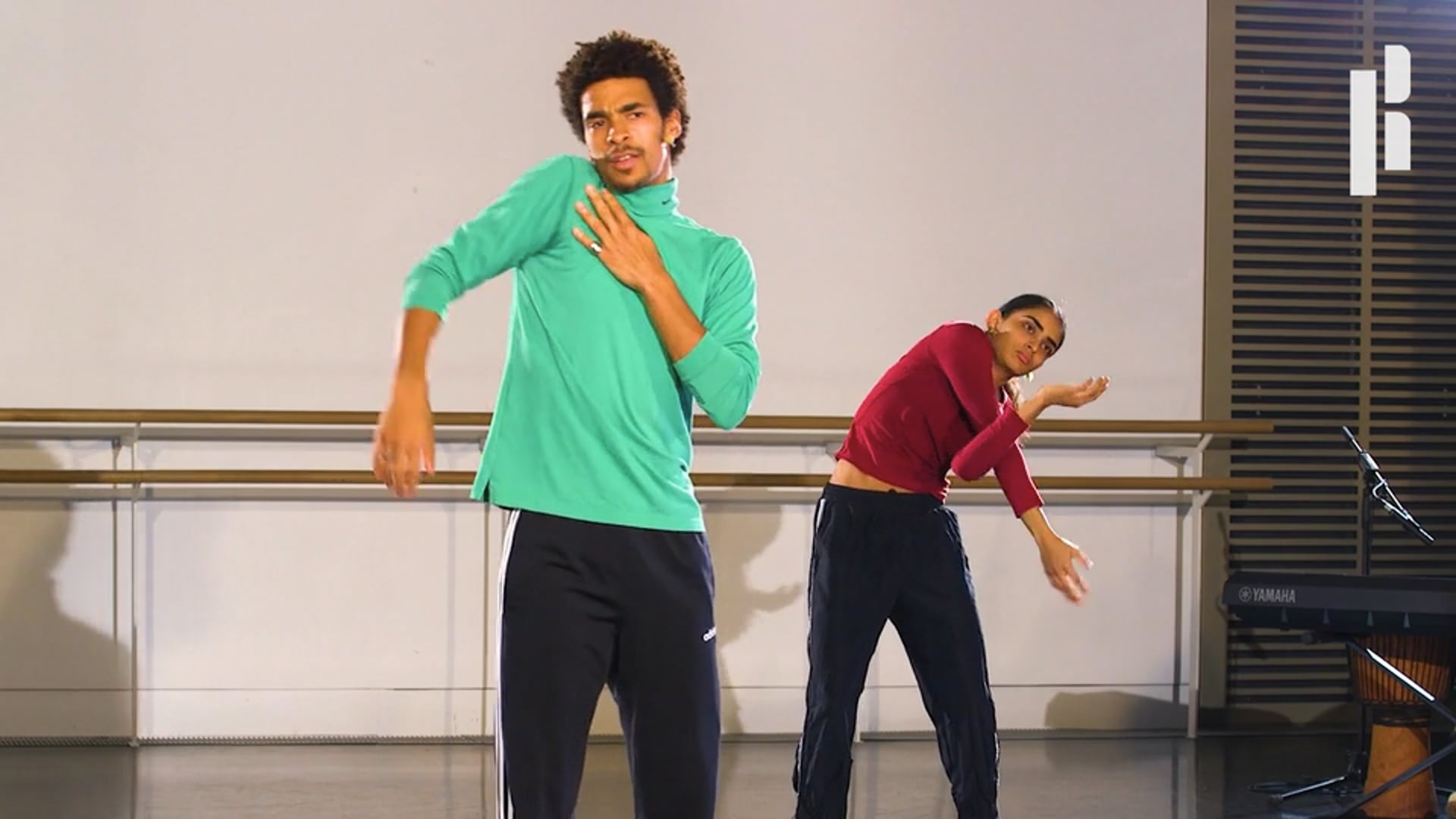 Two men are dancing in a dance studio.