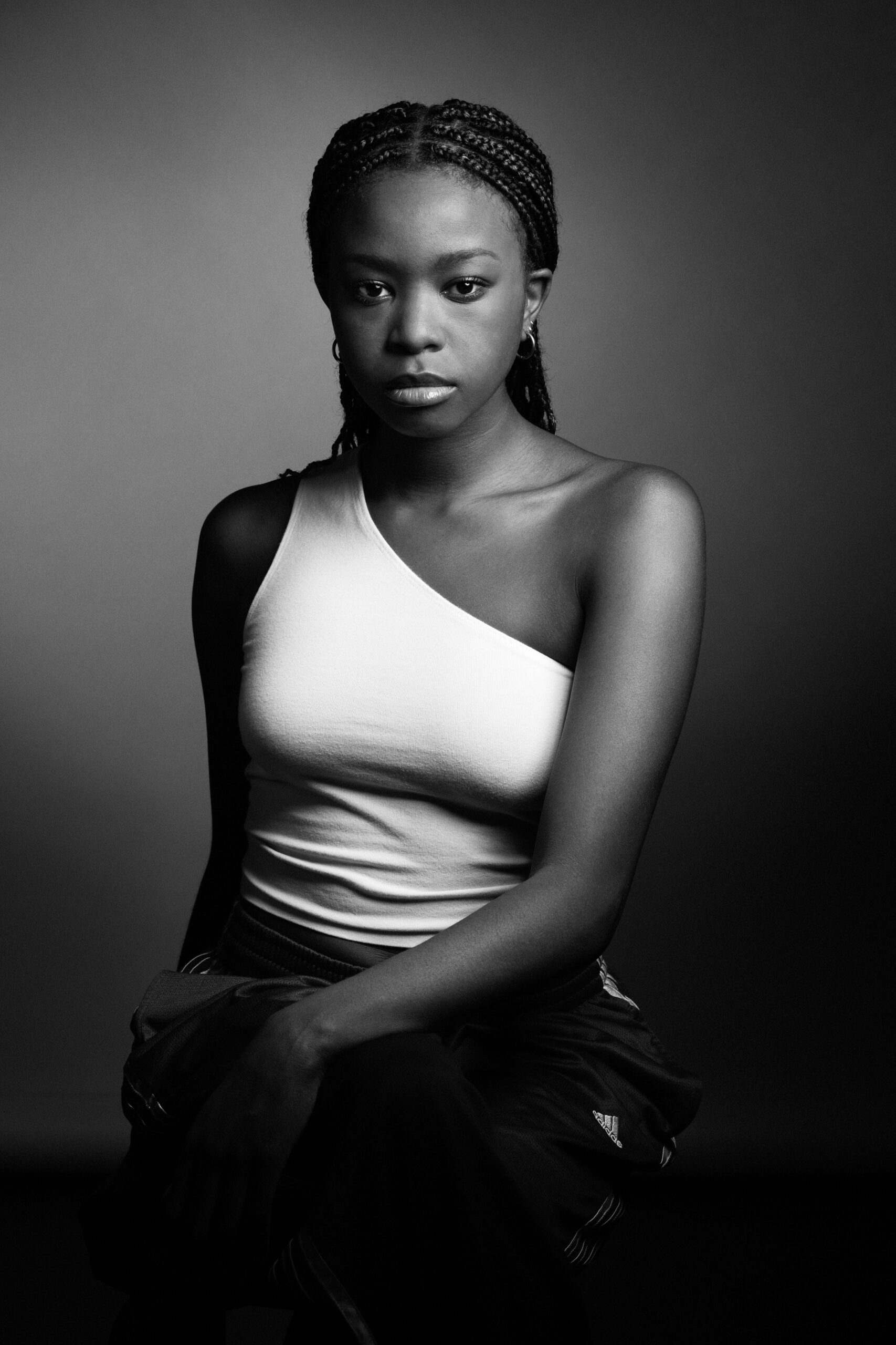 a black and white photo of a woman in a tank top.
