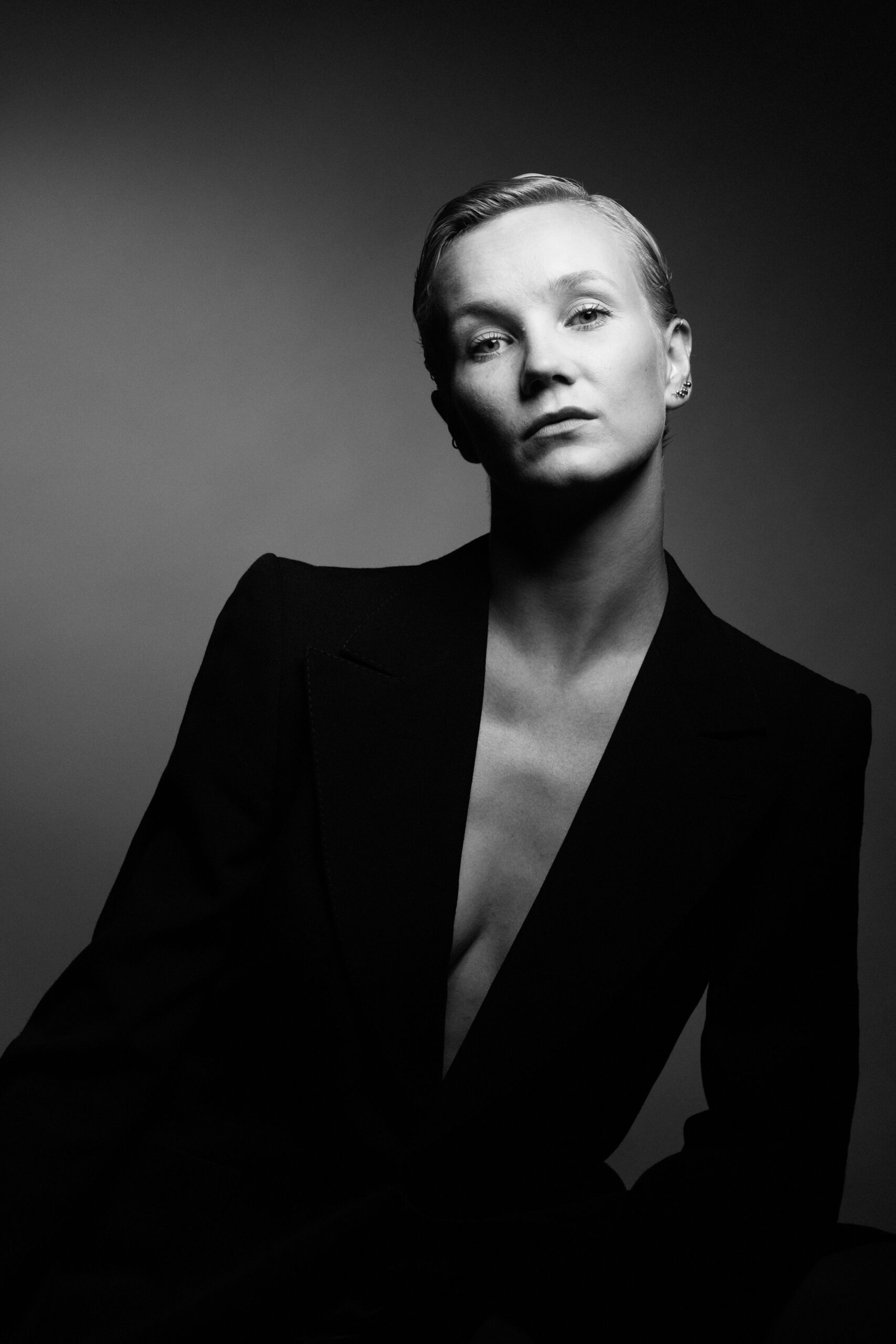 a black and white photo of a woman in a suit.