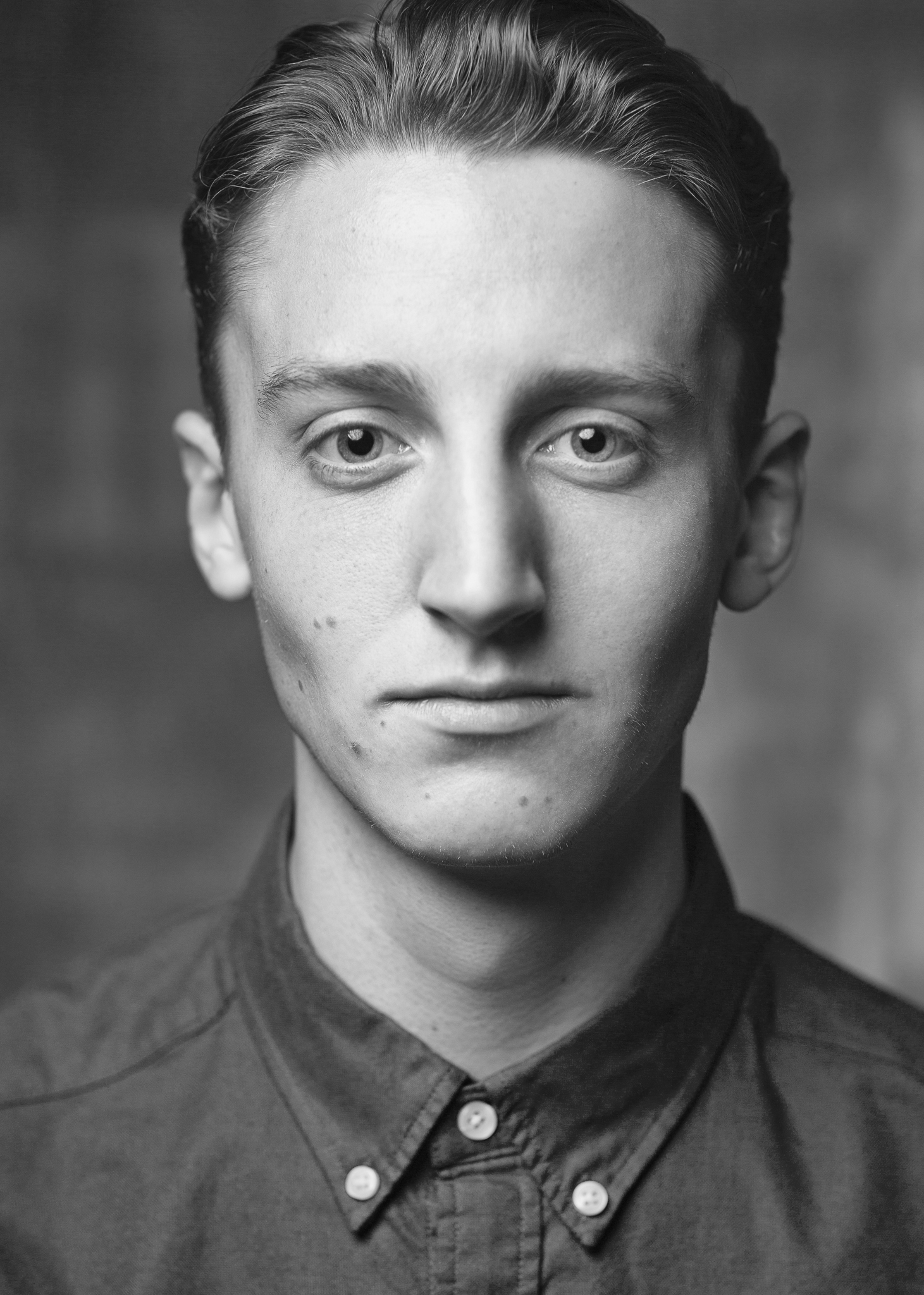 a black and white photo of a young man.