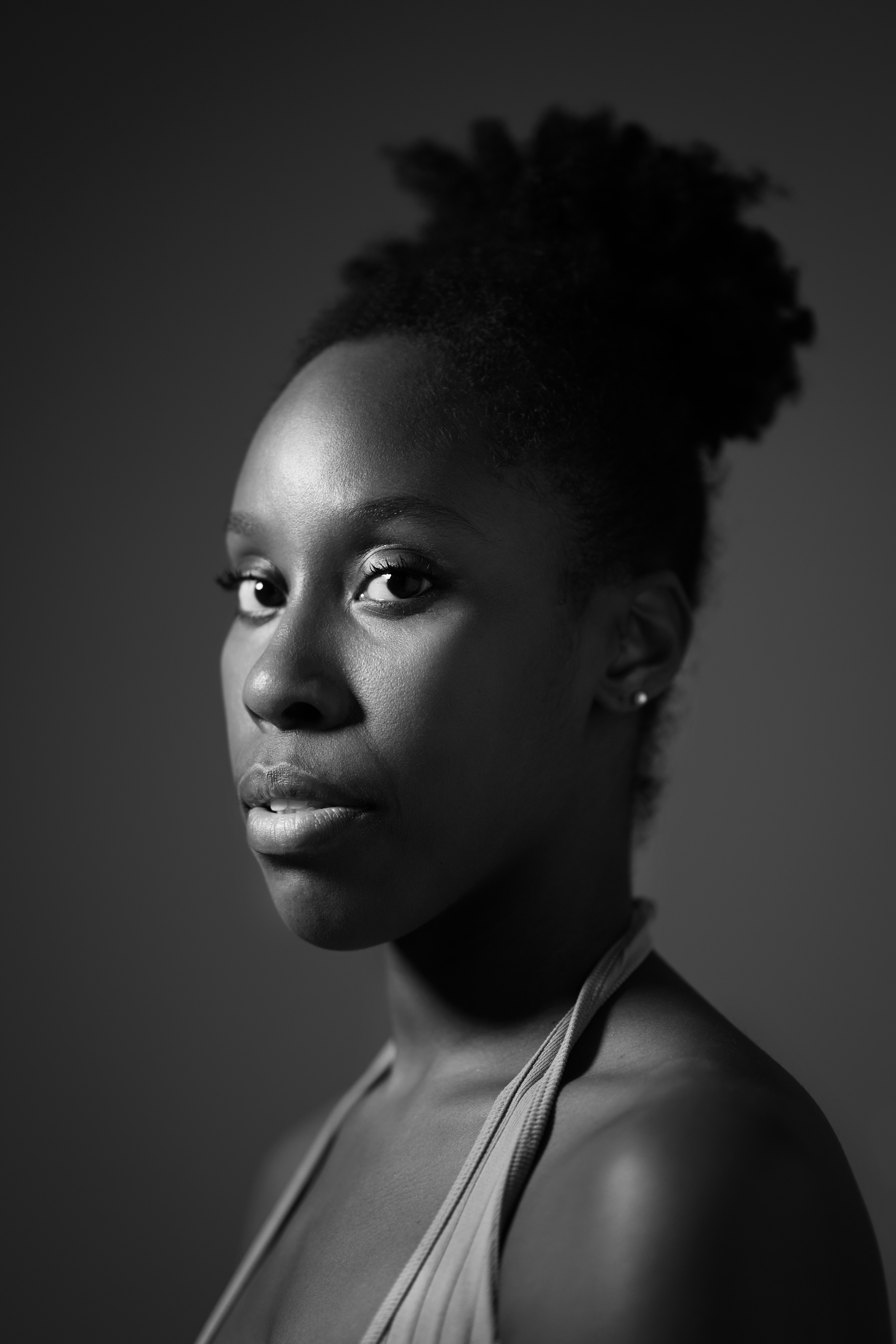 A black and white image of a woman from the shoulders up
