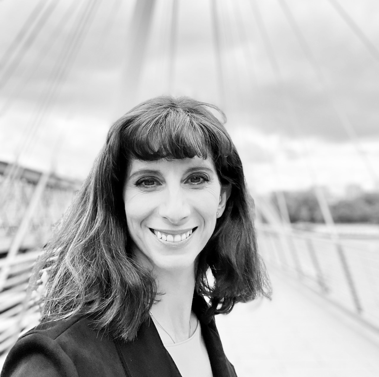a black and white photo of a woman smiling.