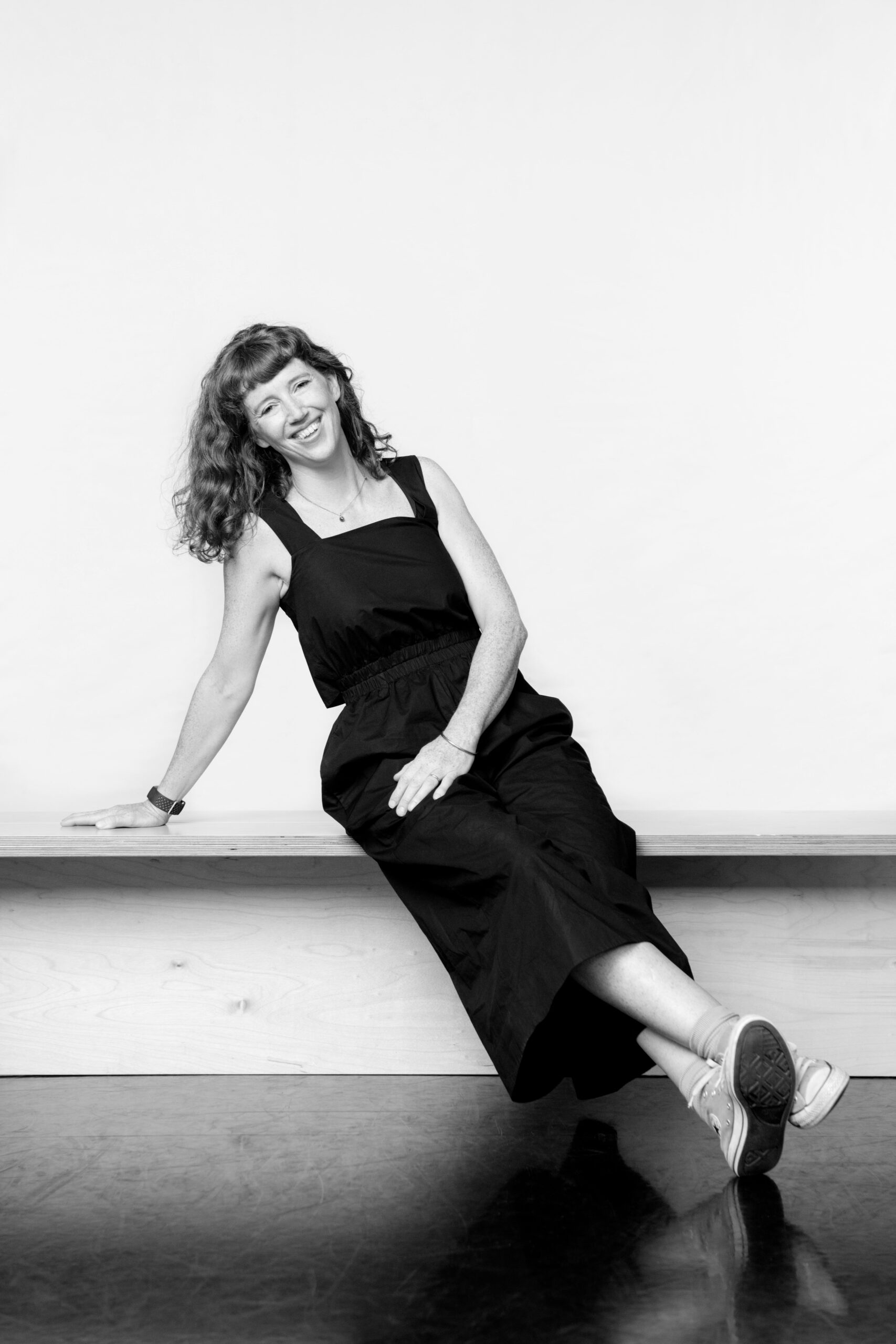 a black and white photo of a woman in a dress.