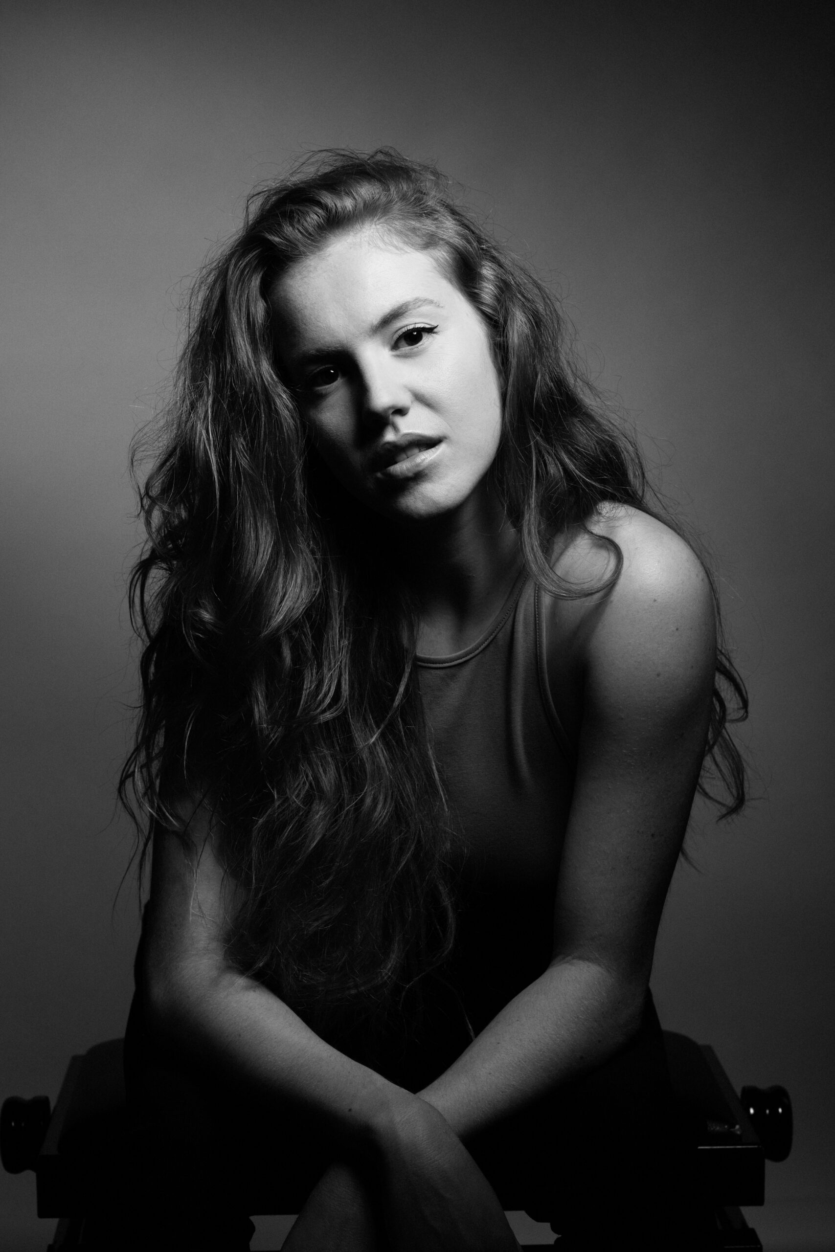 a black and white photo of a woman with long hair.