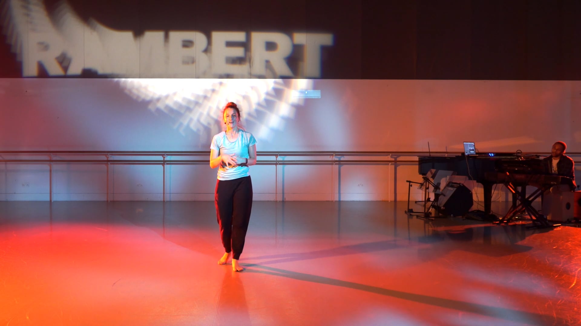 a woman standing on a stage in front of a band.