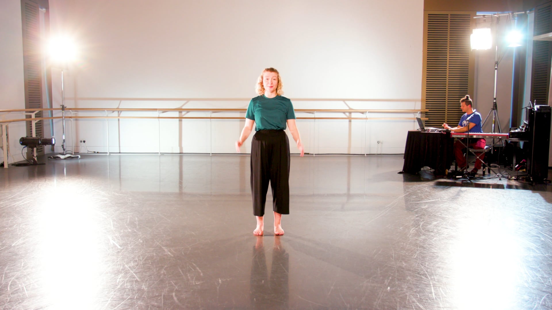 a woman standing on a stage in front of a microphone.