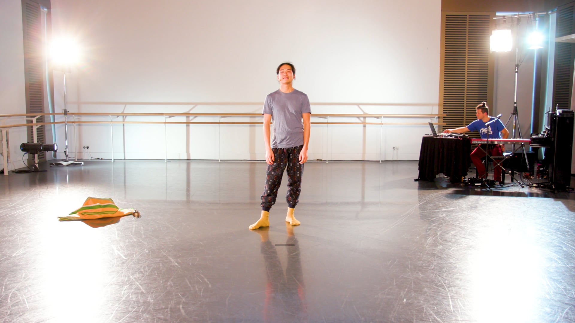 a man standing on a stage in front of a projector.