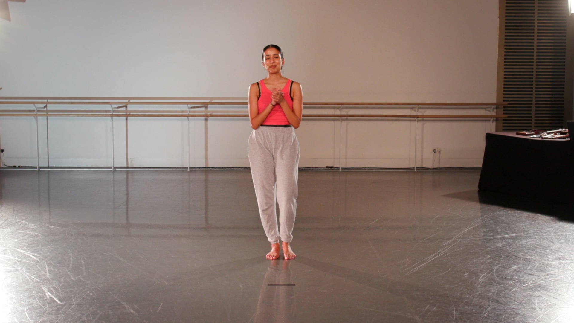 a woman is standing in a dance studio.