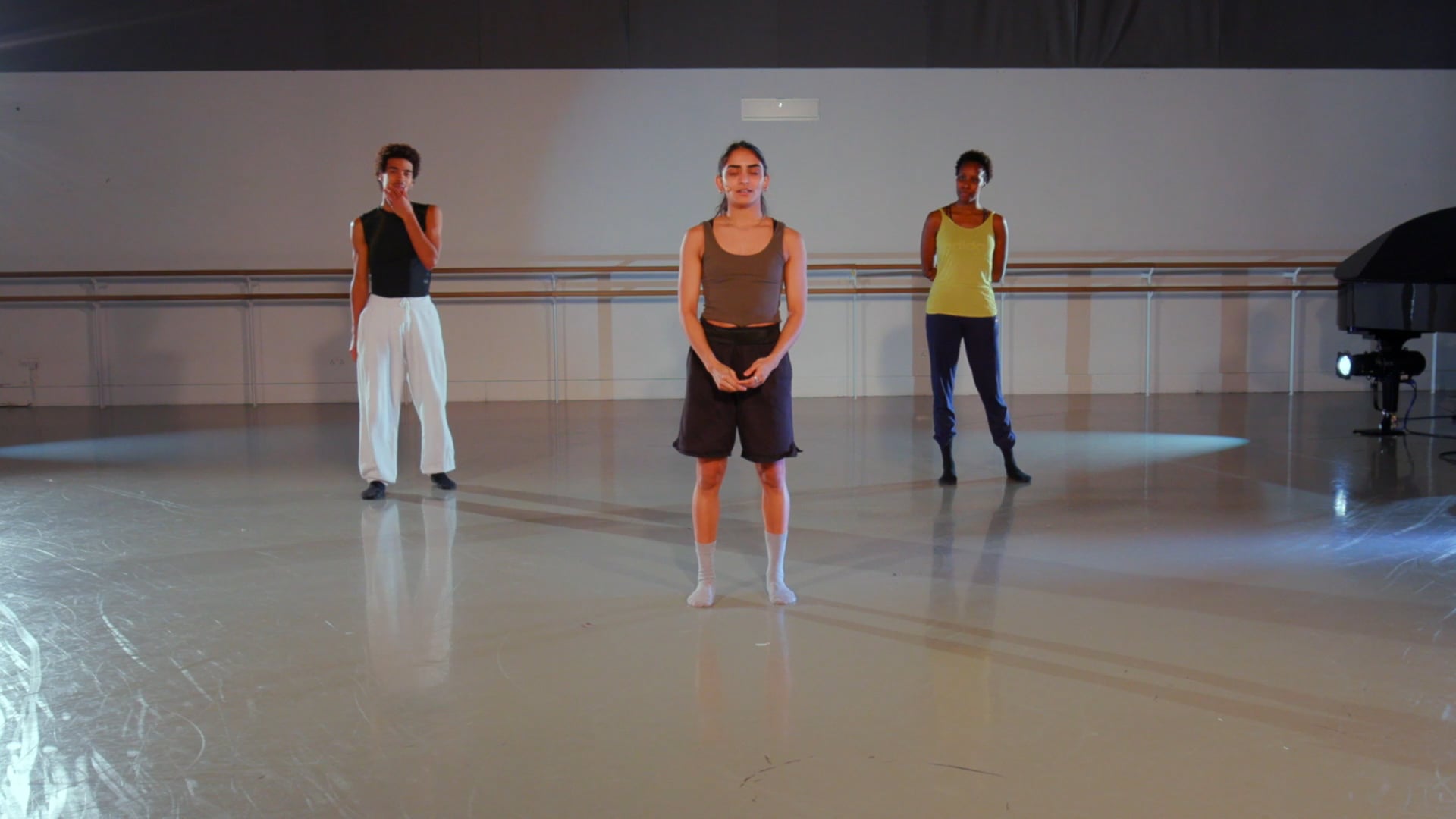 a group of people standing on top of a dance floor.