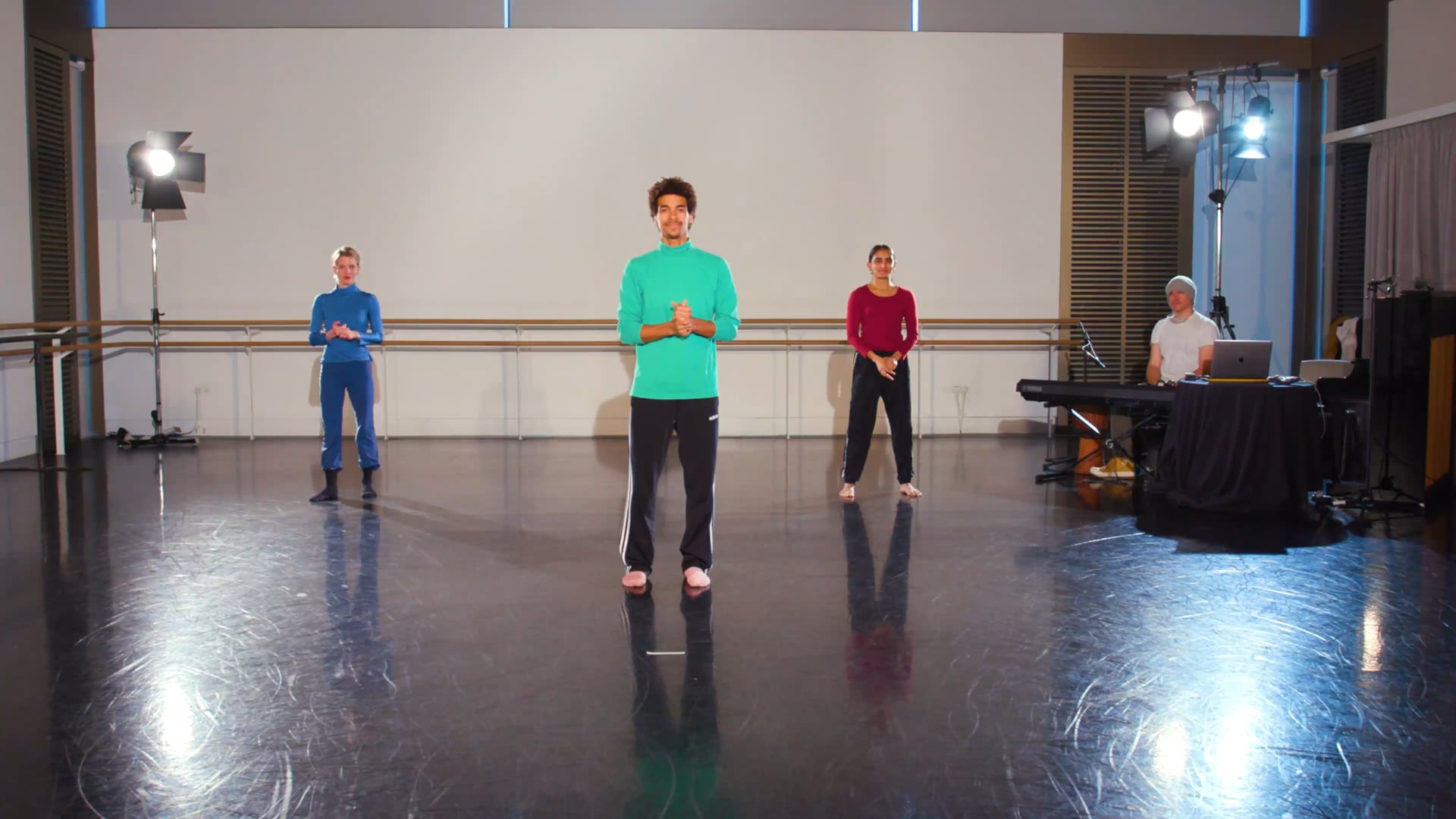 a group of people standing on top of a dance floor.