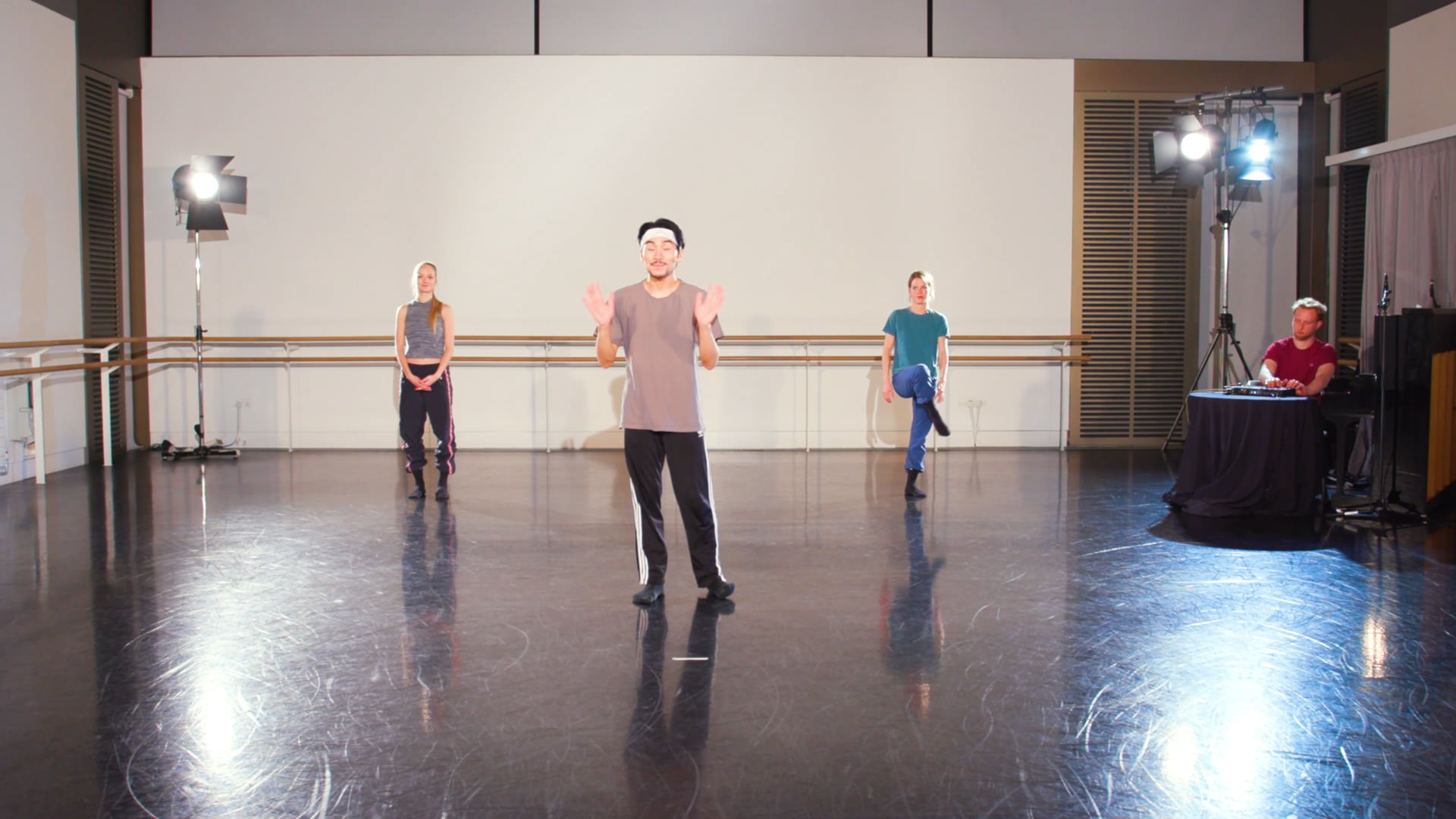 a group of people standing on top of a dance floor.