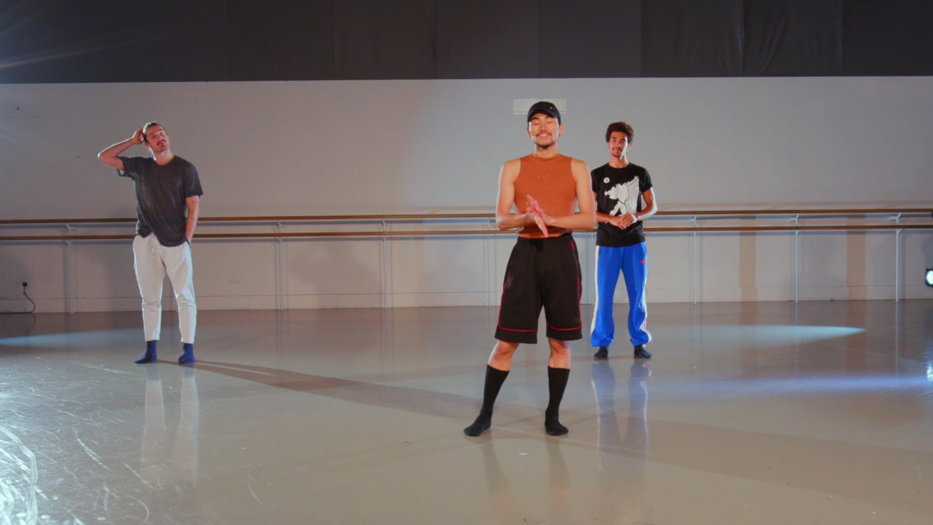 a group of people standing on top of a dance floor.