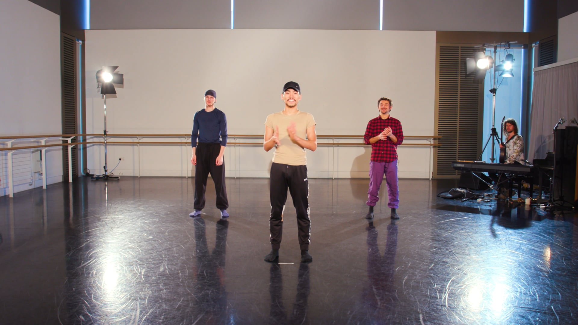a group of men standing on top of a dance floor.