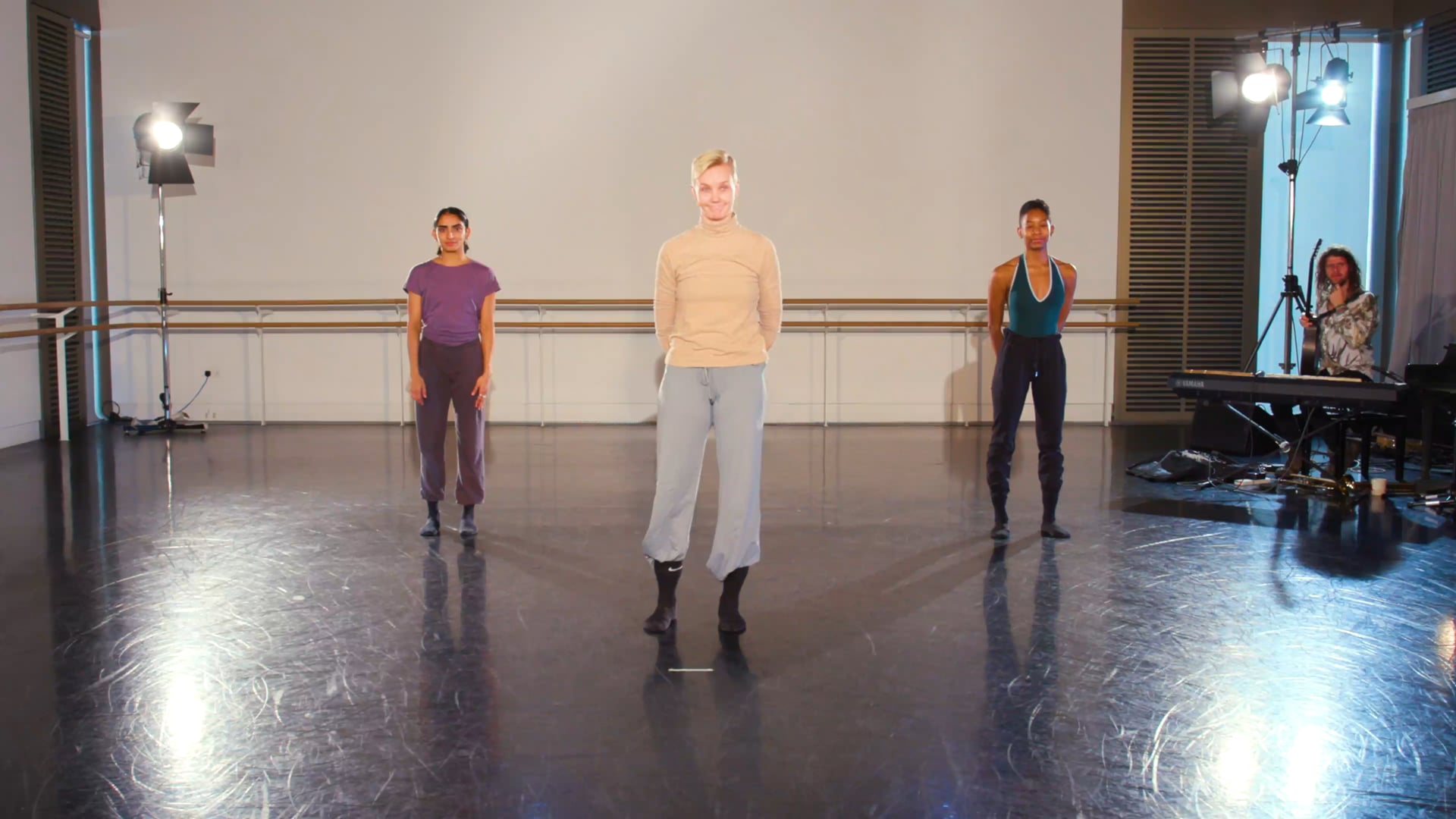 a group of people standing on top of a dance floor.