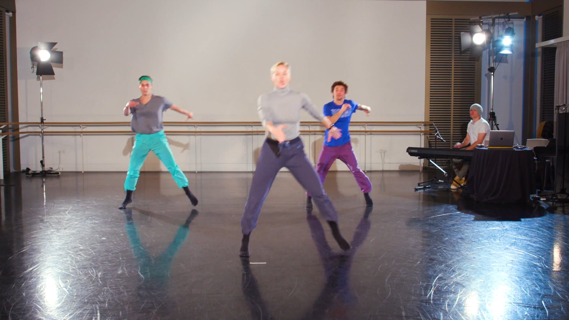 a group of people standing on top of a dance floor.