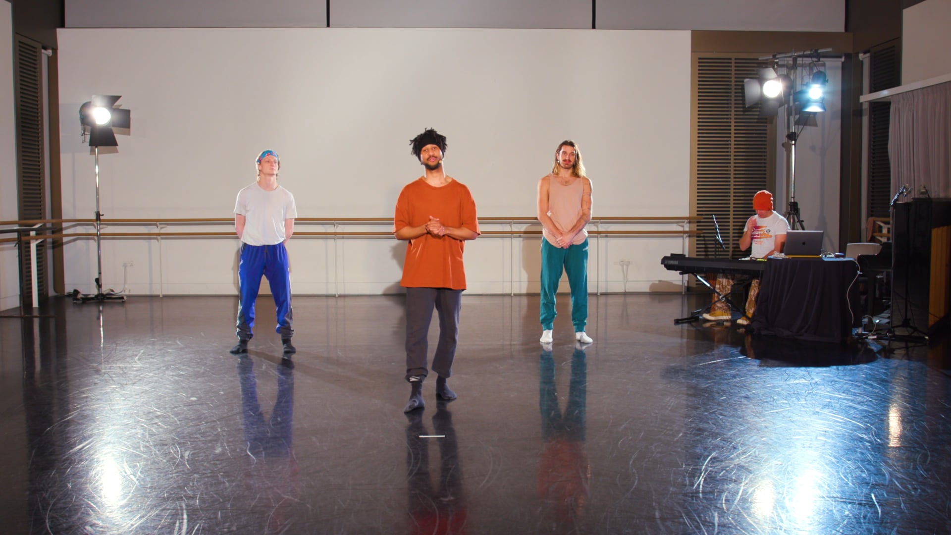 a group of men standing on top of a dance floor.