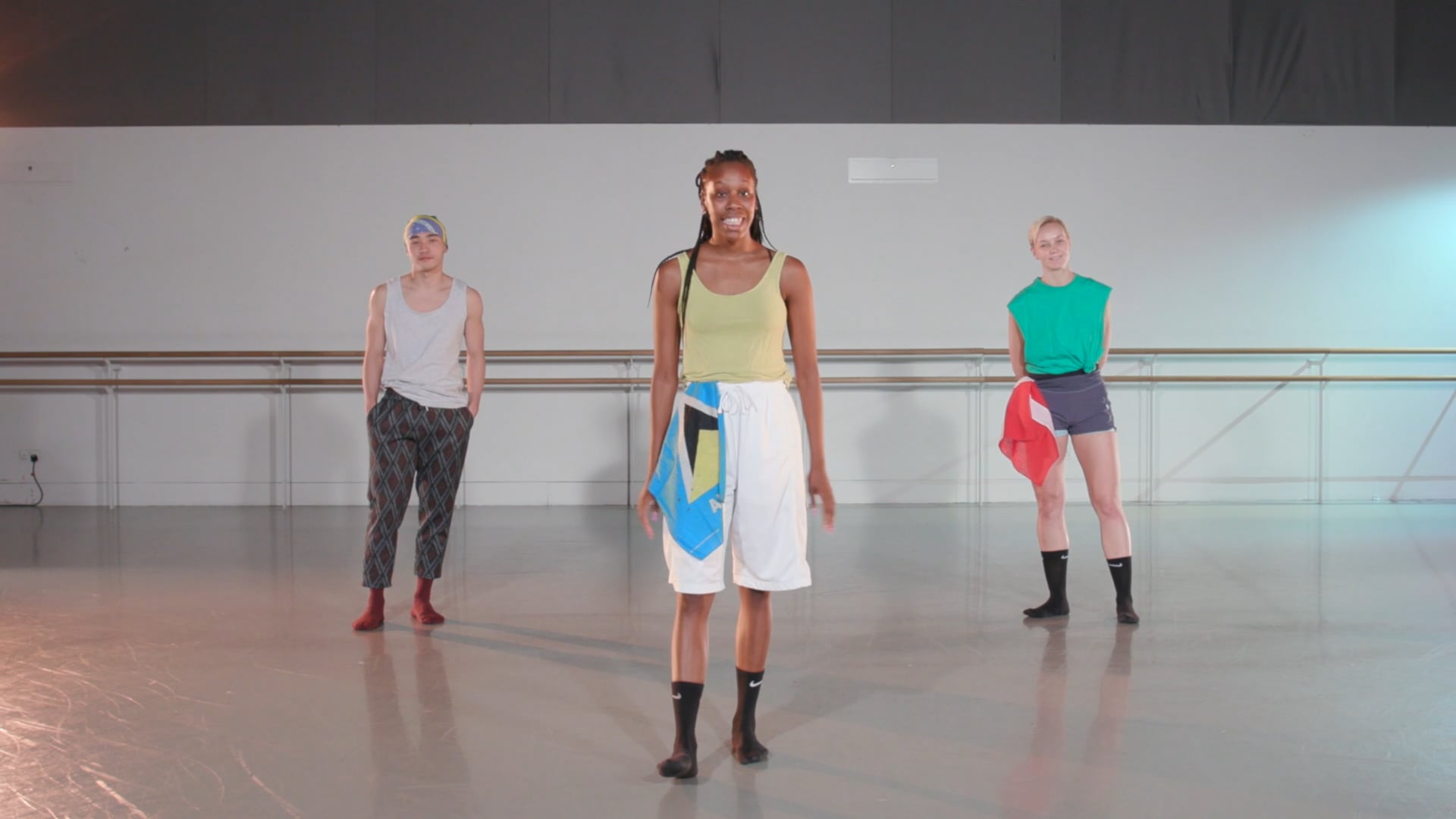 a group of people standing around each other in a room.