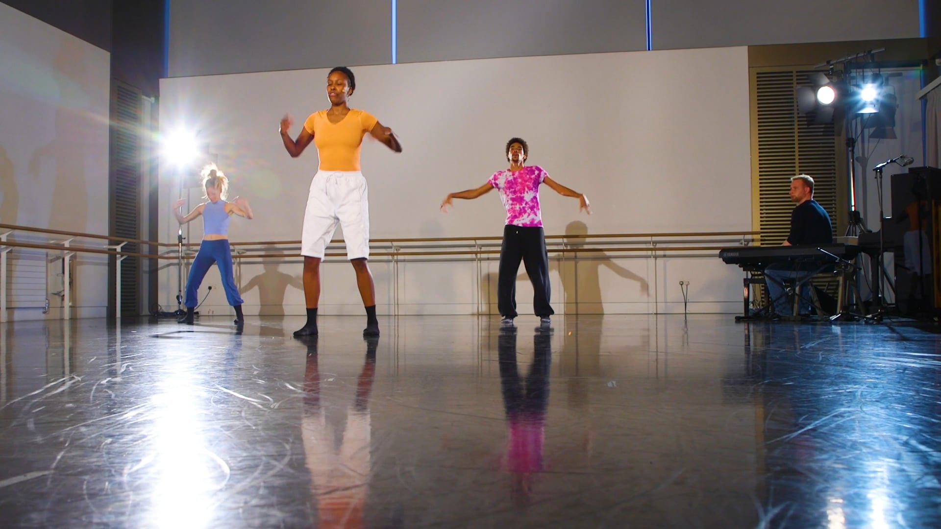 a group of people standing on top of a dance floor.