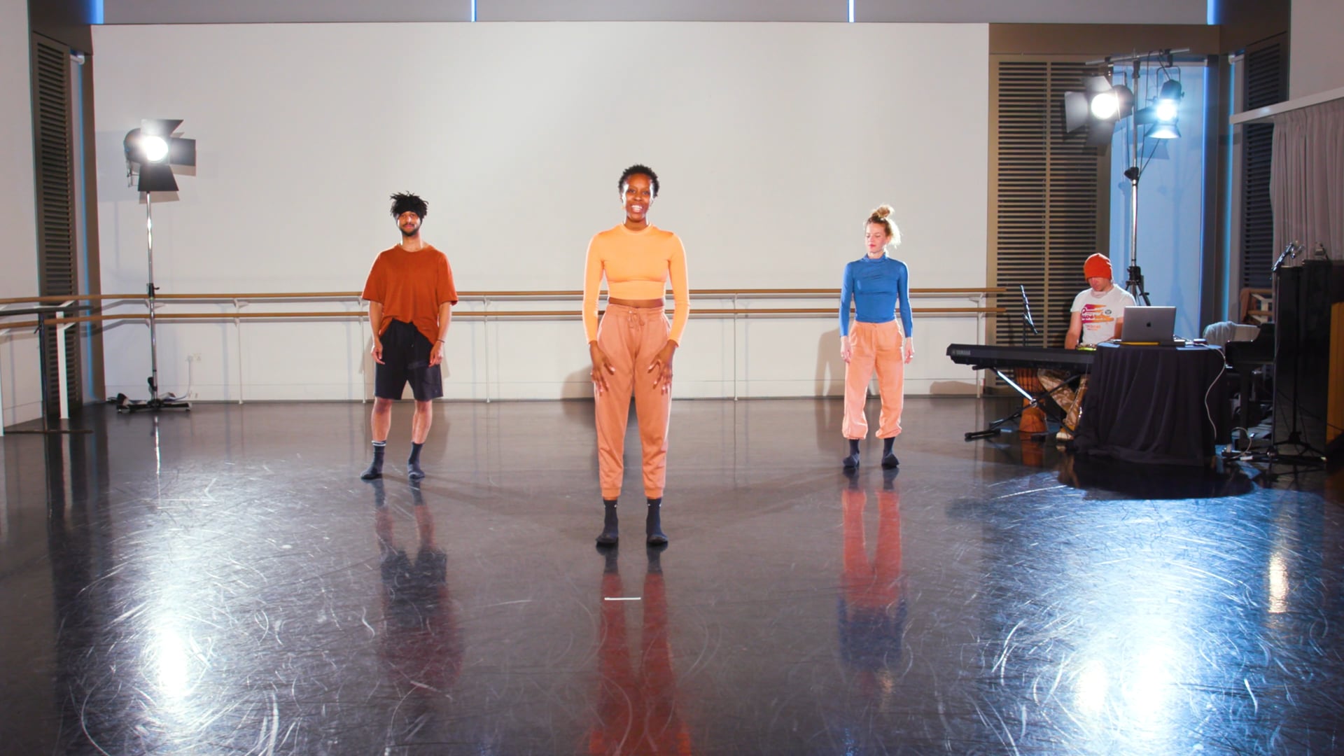 a group of people standing on top of a dance floor.