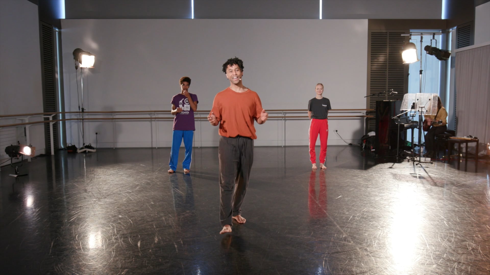 a group of people standing on top of a dance floor.