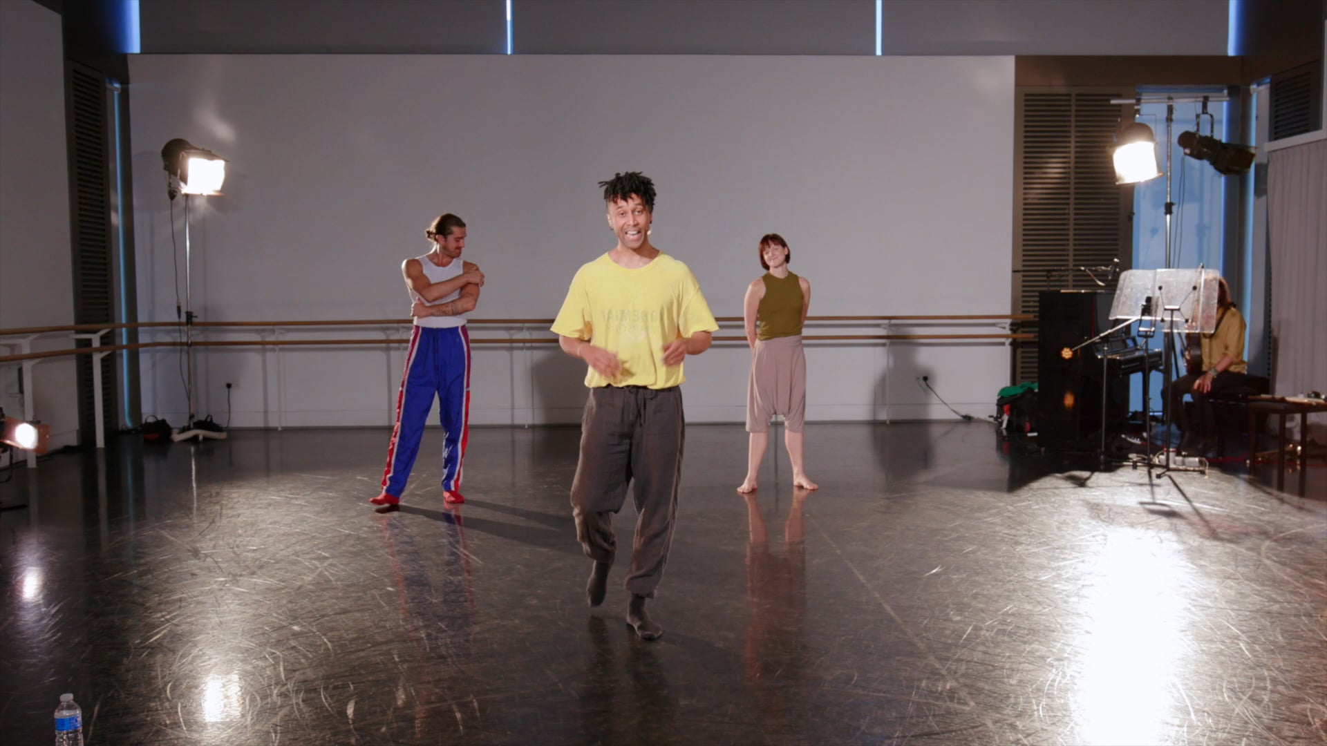 a group of people standing on top of a dance floor.