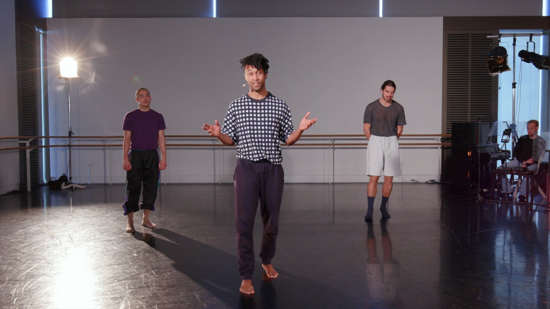 a group of men standing in a dance studio.