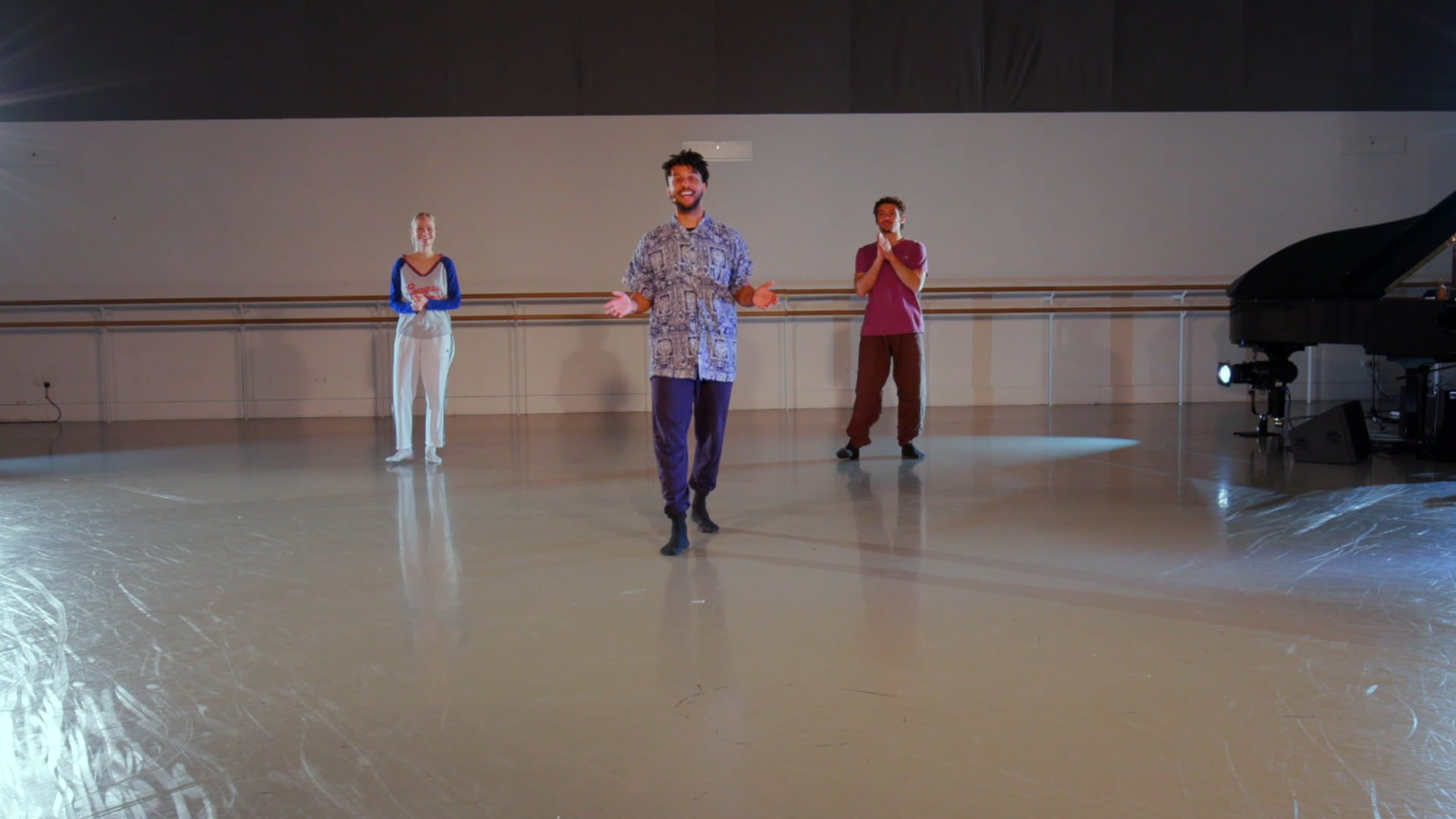 a group of people standing on a dance floor.