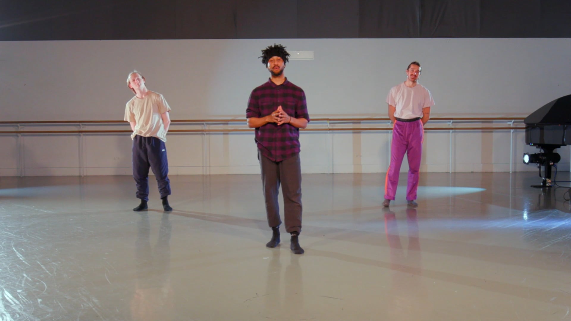 a group of men standing on top of a dance floor.