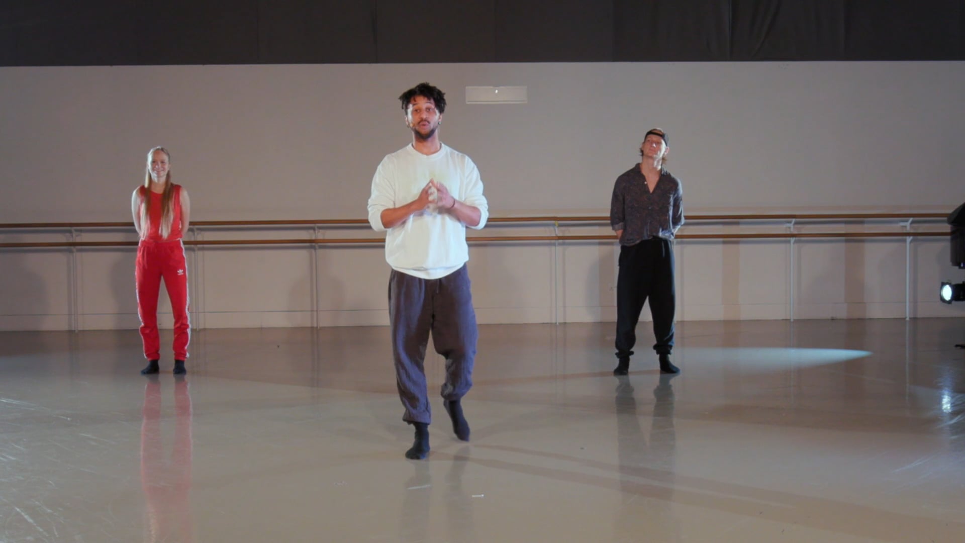a group of people standing on top of a dance floor.