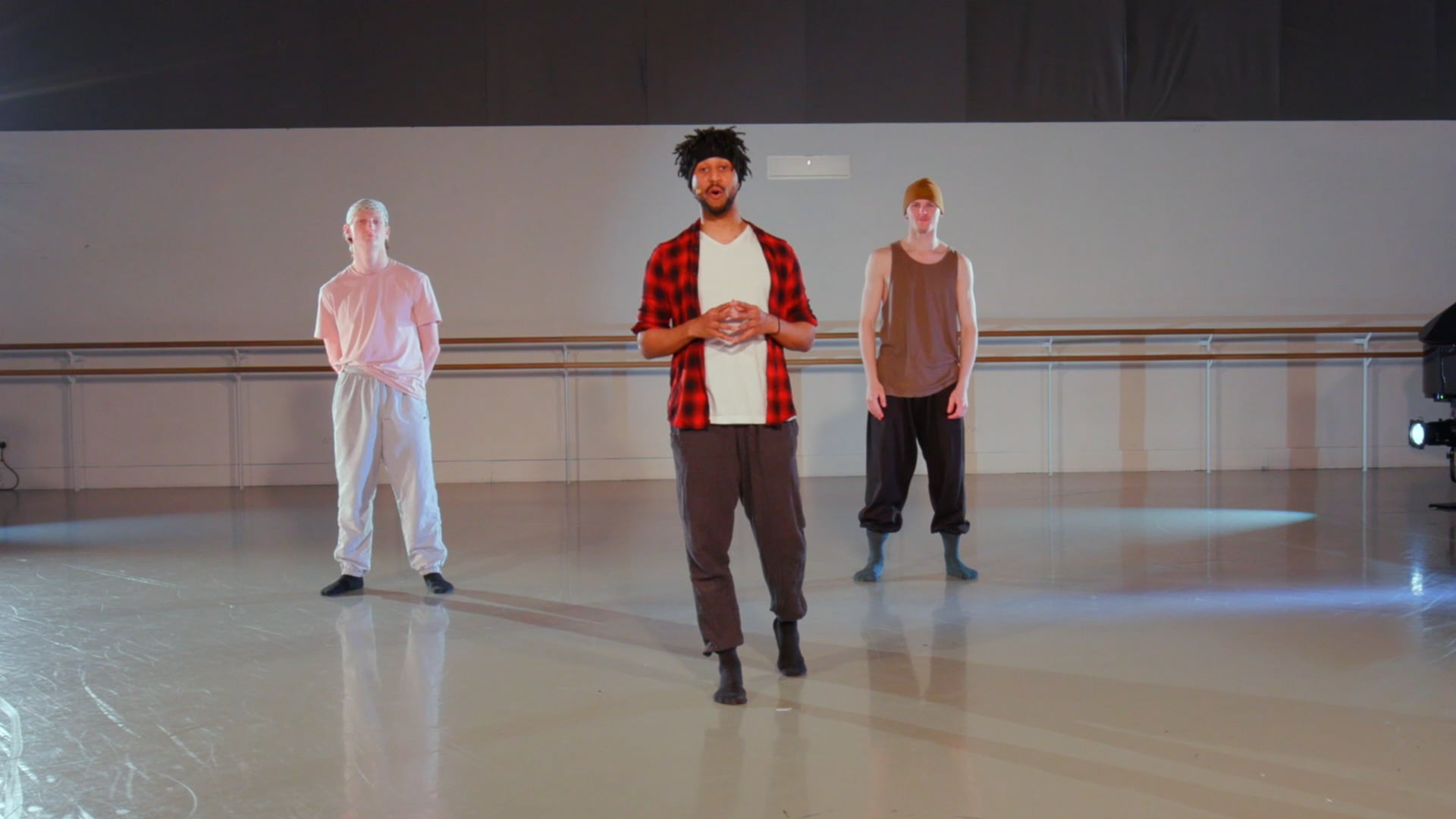 a group of men standing on top of a dance floor.