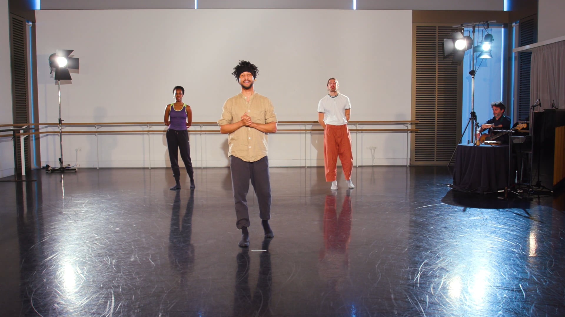 a group of people standing on a dance floor.