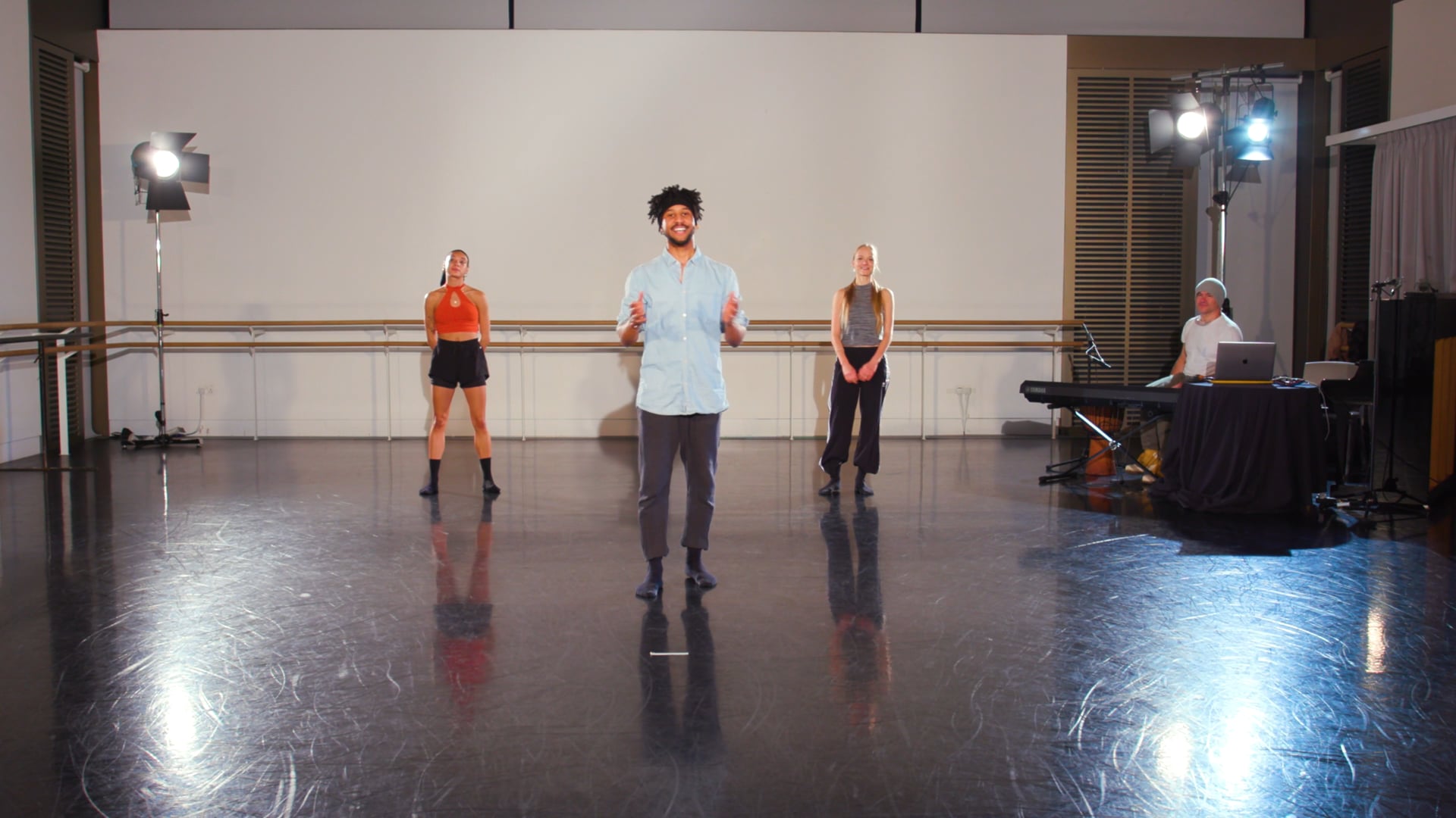 a group of people standing on top of a dance floor.