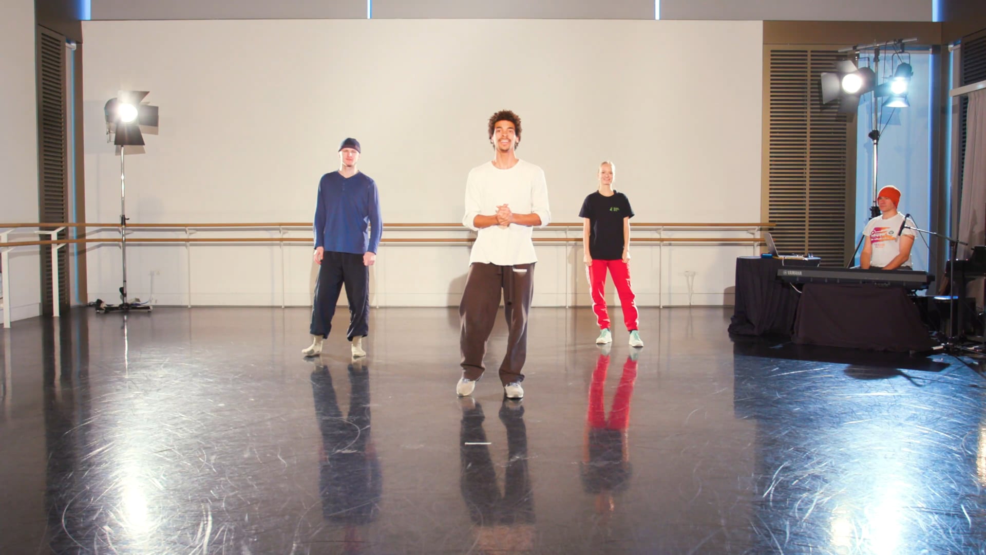 a group of young men standing on top of a dance floor.