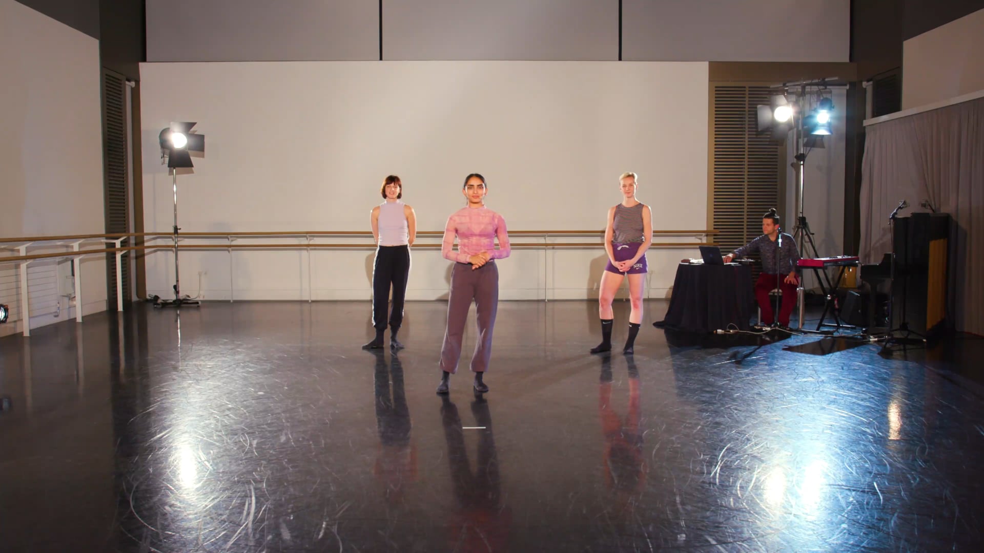 a group of people standing on top of a dance floor.