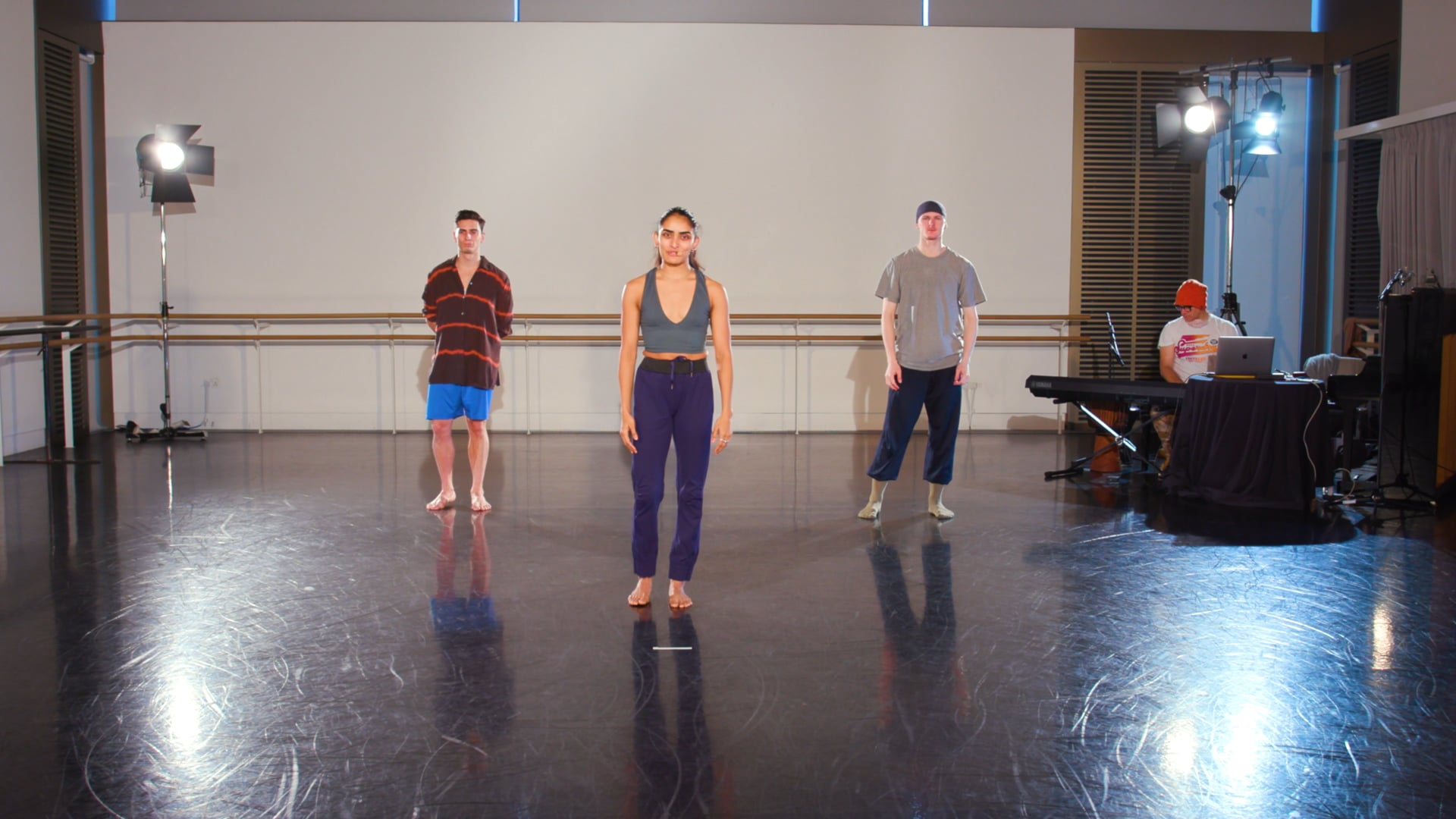 a group of people standing on top of a dance floor.