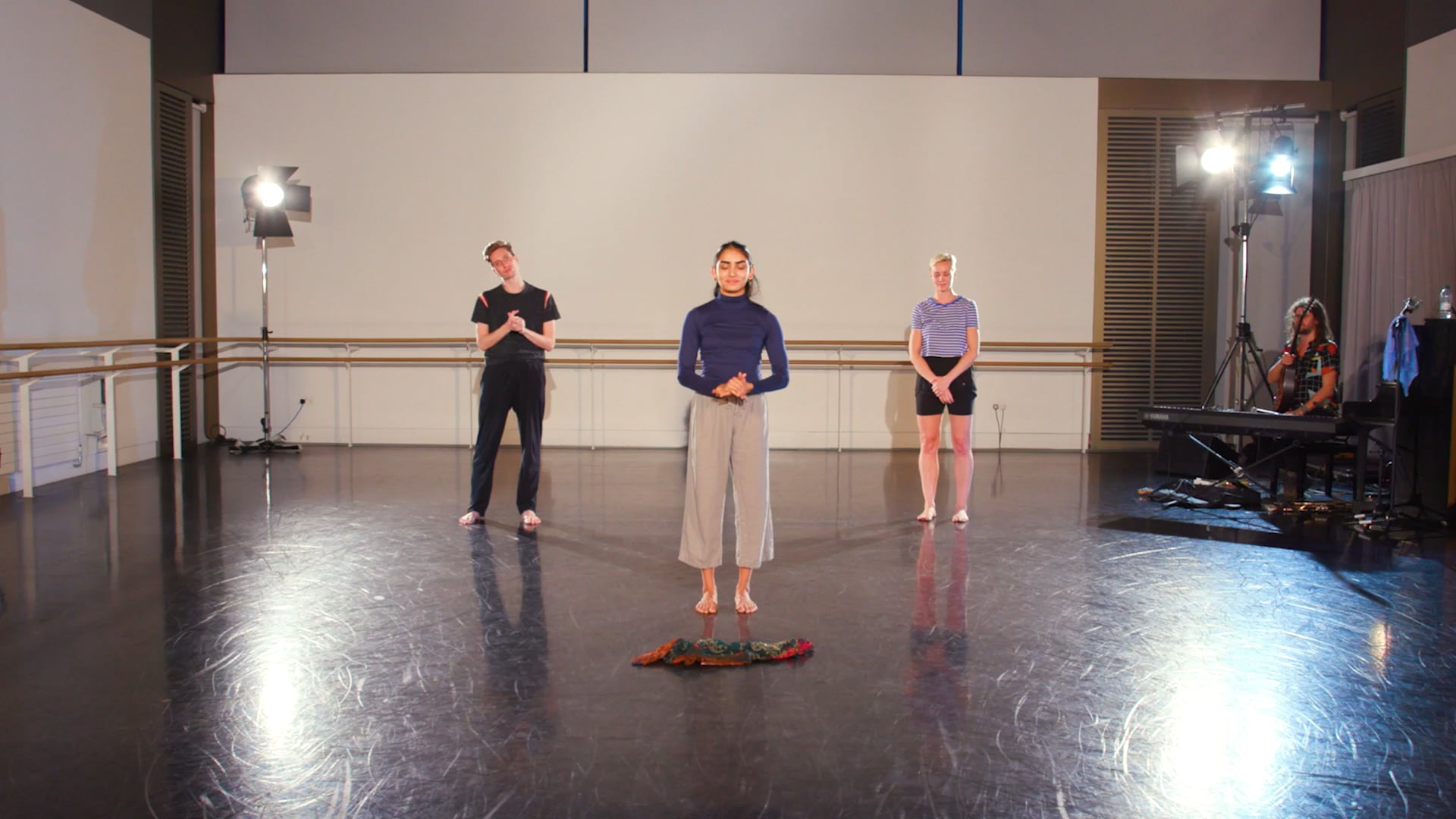 a group of people standing on top of a dance floor.