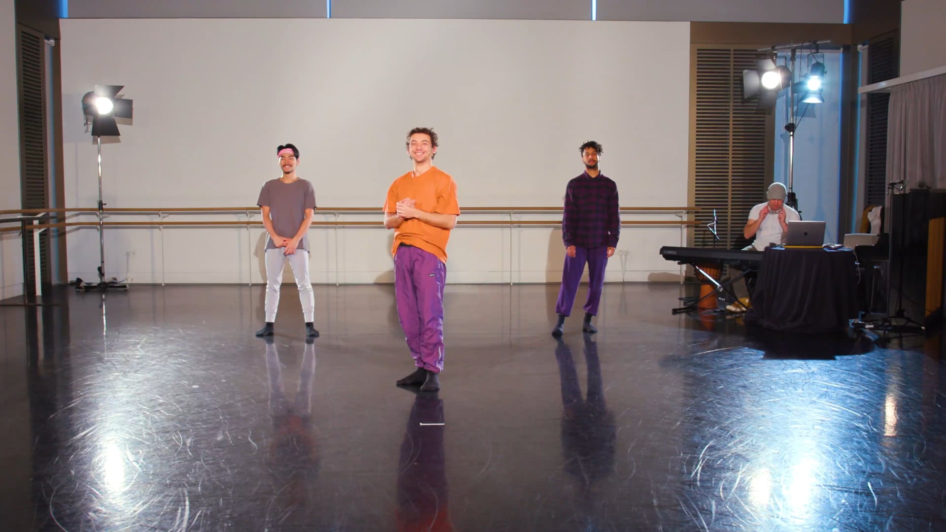 a group of young men standing on top of a dance floor.