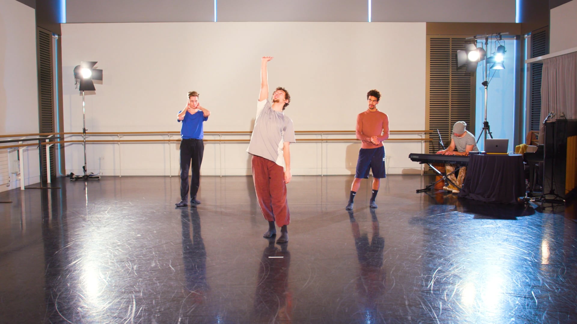 a group of people standing on top of a dance floor.