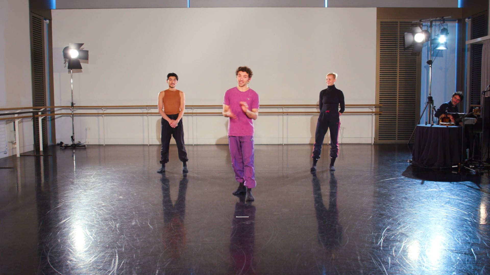 a group of young men standing on top of a dance floor.