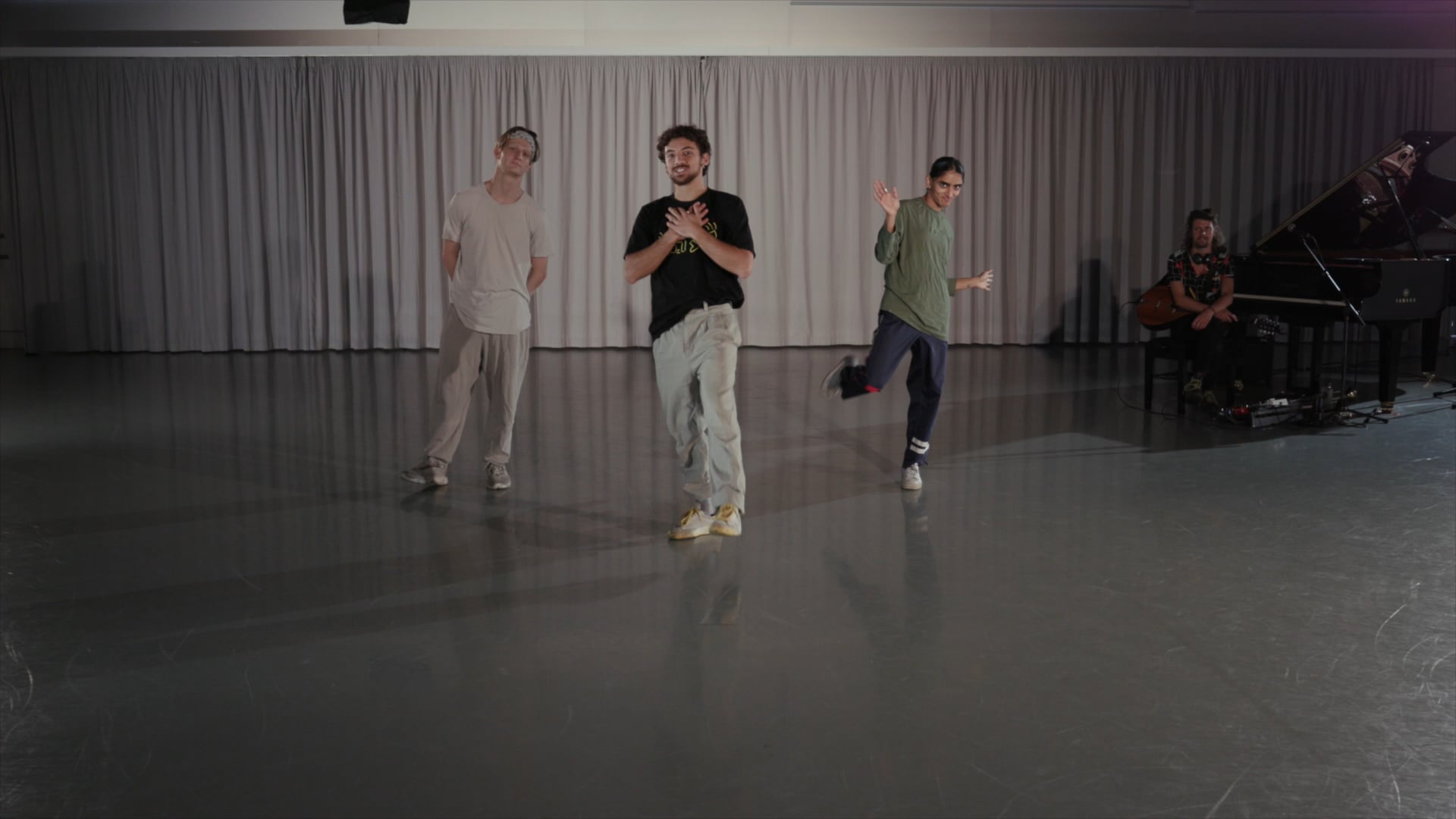 a group of young men standing on top of a dance floor.