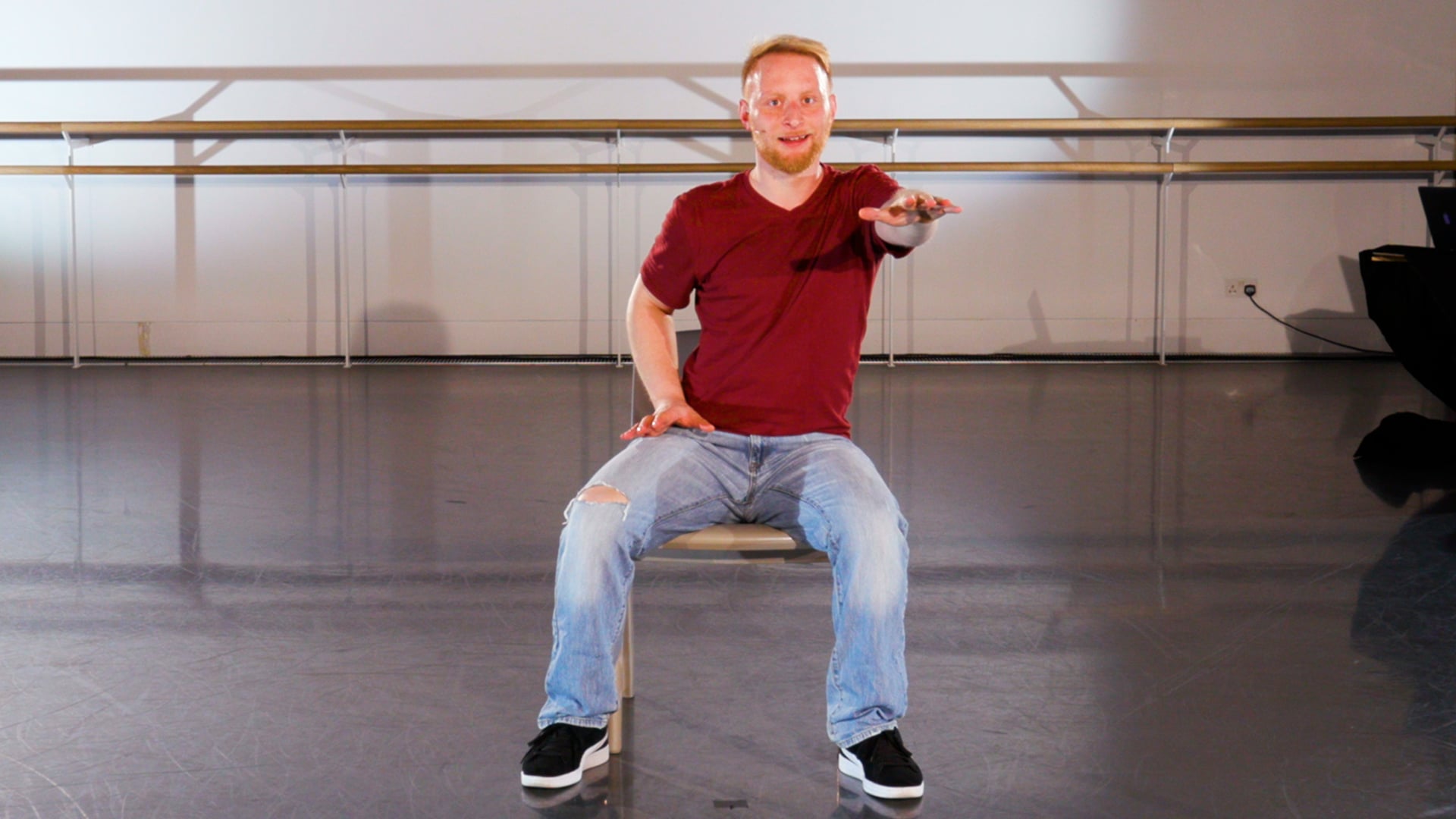 a man sitting on a chair in a room.