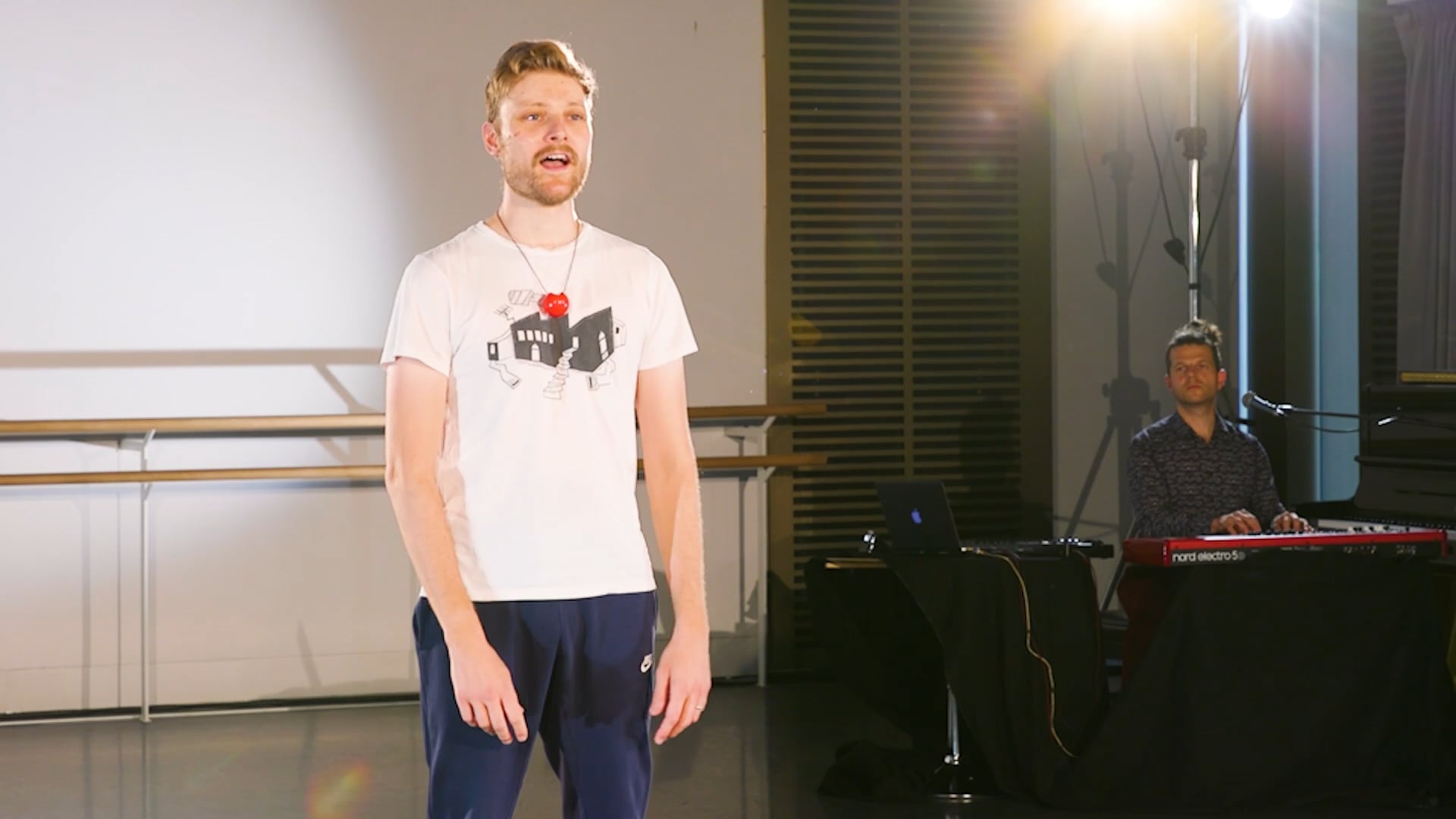 a man standing in front of a camera in a room.
