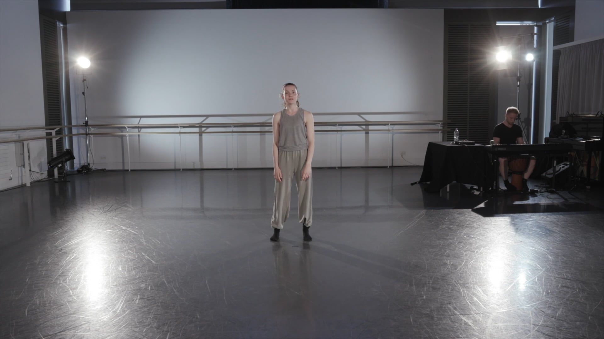a woman standing on a stage in front of a crowd.