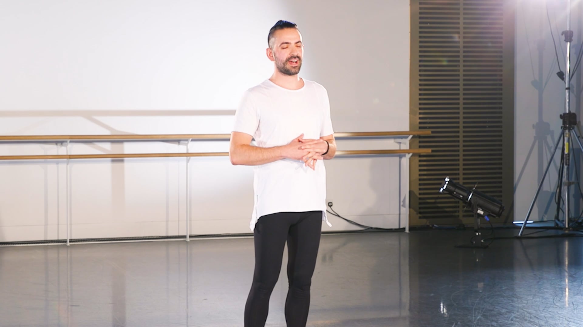 a man in a white shirt and black pants.