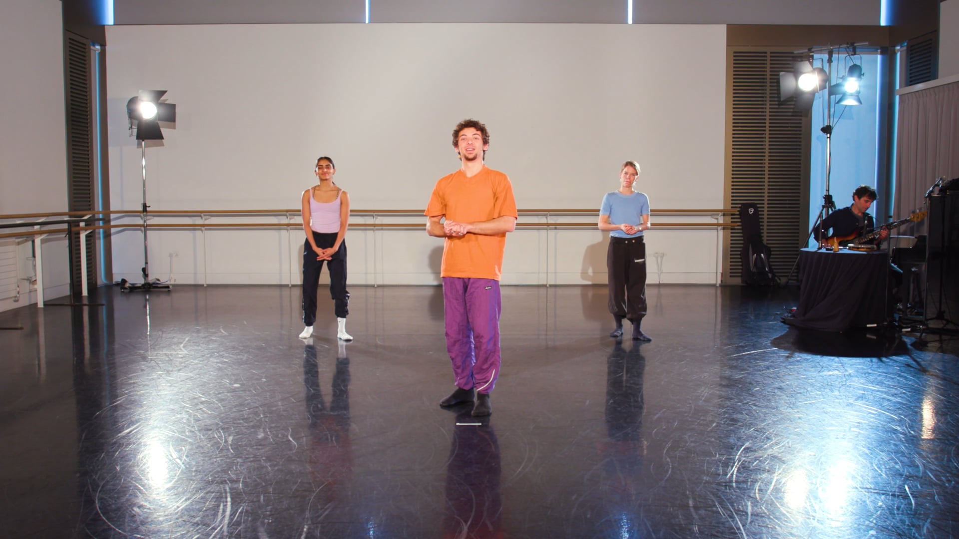 a group of people standing on top of a dance floor.