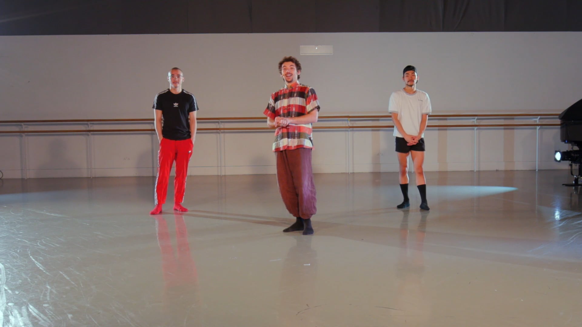 a group of men standing on top of a dance floor.