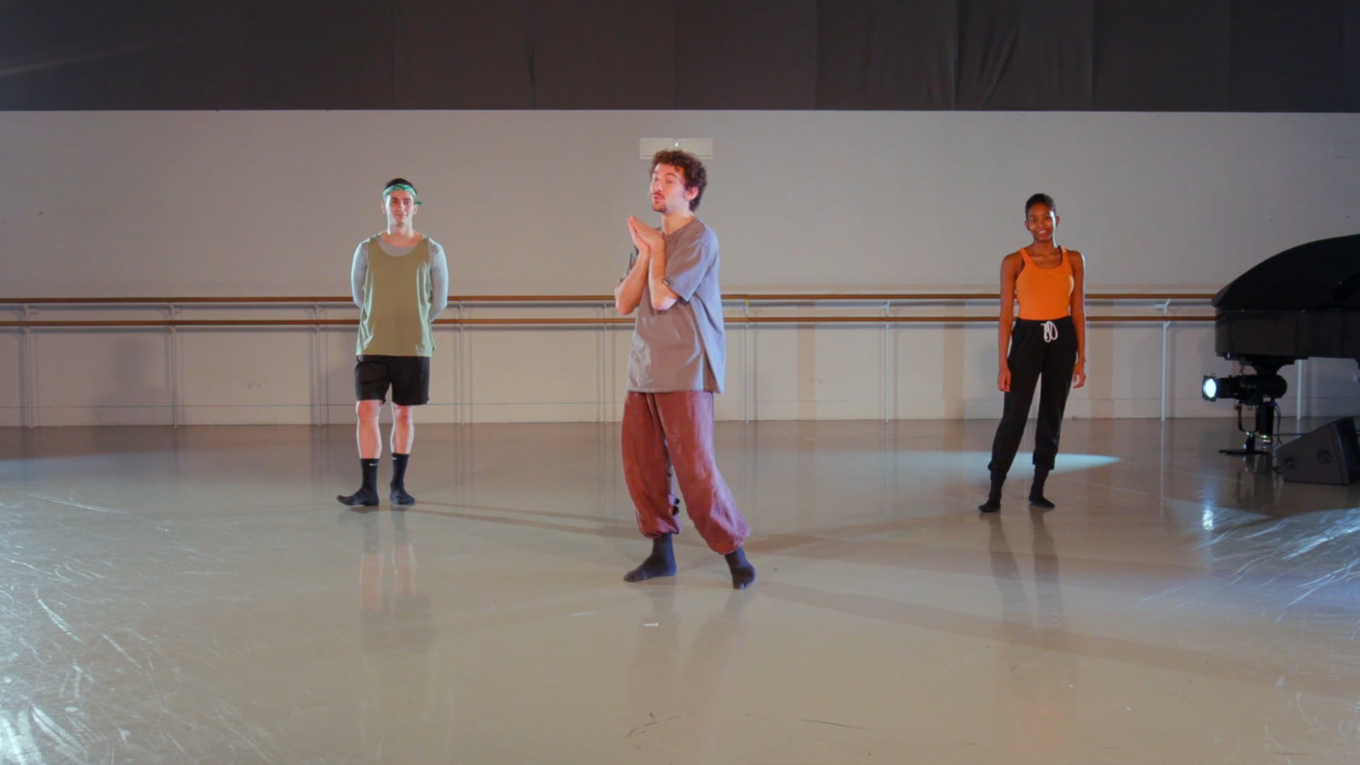 a group of young men standing on top of a dance floor.